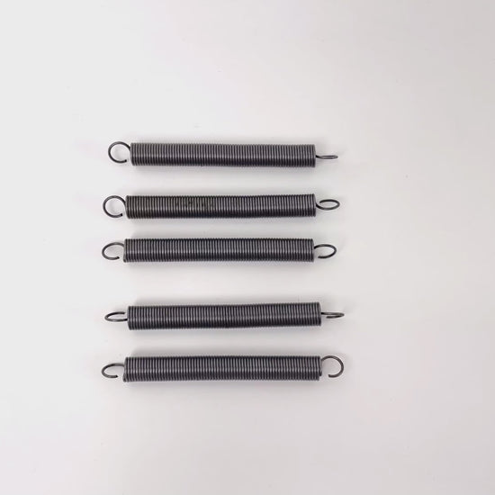 Cutter tension spring for strapping machine